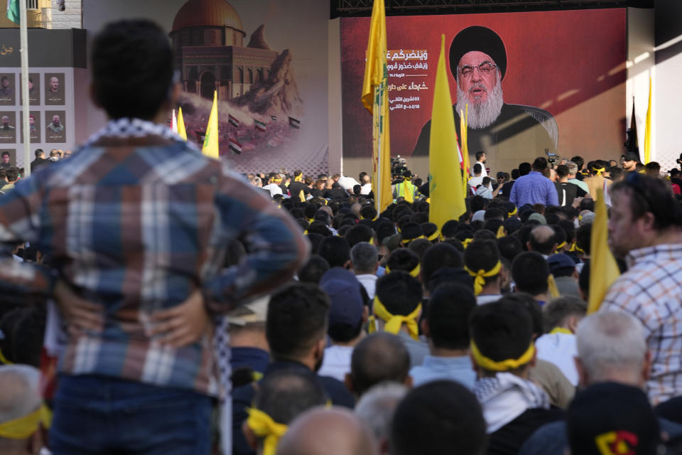 Supporters of the Iranian-backed Hezbollah group listen to Hezbollah leader Sayyed Hassan Nasrallah, who addresses a speech via a video link, during a rally to commemorate Hezbollah fighters who killed in South Lebanon last few weeks while fighting against the Israeli forces, in Beirut, Lebanon, Friday, Nov. 3, 2023. Nasrallah's speech had been widely anticipated throughout the region as a sign of whether the Israel-Hamas conflict would spiral into a regional war. (AP Photo/Hussein Malla)