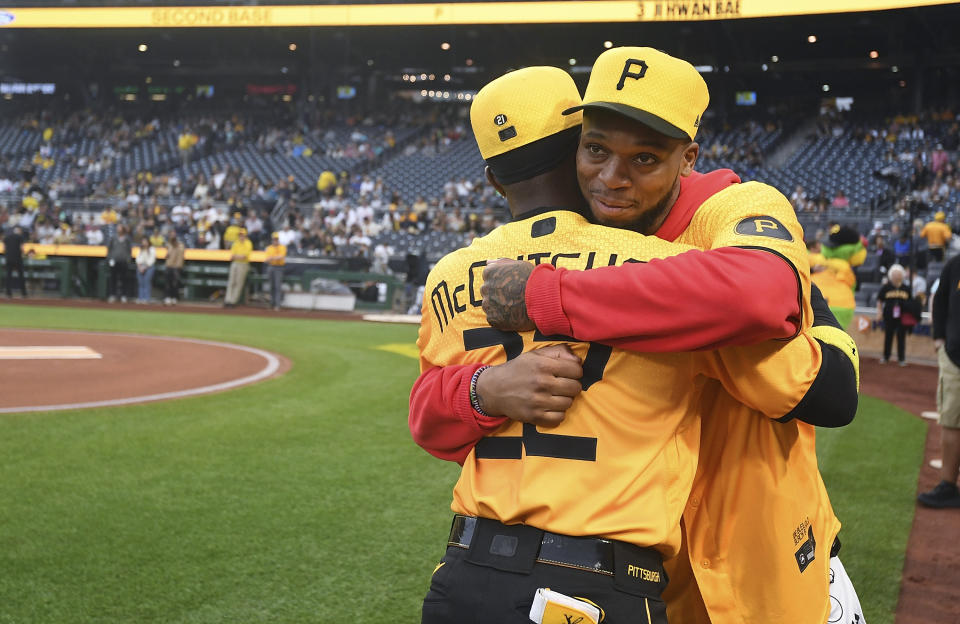 Buffalo Bills safety Damar Hamlin, rear, hugs Pittsburgh Pirates designated hitter Andrew McCutchen before the Pirates' baseball game against the San Diego Padres, Tuesday, June 27, 2023, in Pittsburgh. (AP Photo/Justin Berl)