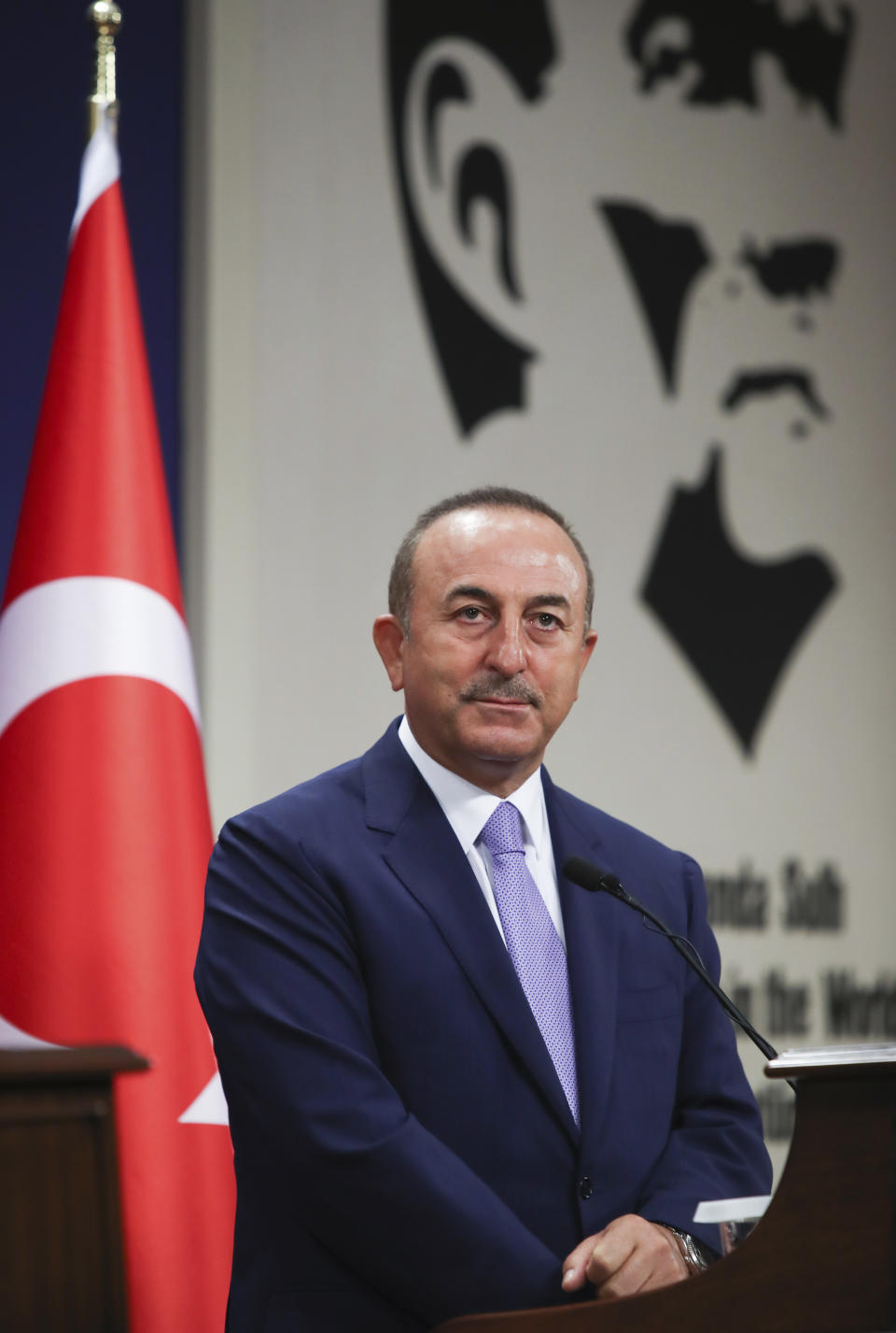 Turkey's Foreign Minister Mevlut Cavusoglu speaks during news conference in Ankara, Turkey, Tuesday, Aug. 11, 2020. Tension remains high between Greece and Turkey, whose warships are in the eastern Mediterranean where Turkey has sent a research vessel to carry out seismic research for energy resources in an area Greece says is on its continental shelf. Cavusoglu said Turkey was determined press ahead with its efforts to search for resources in the Eastern Mediterranean. (Cam Ozdel/Turkish Foreign Ministry via AP, Pool)