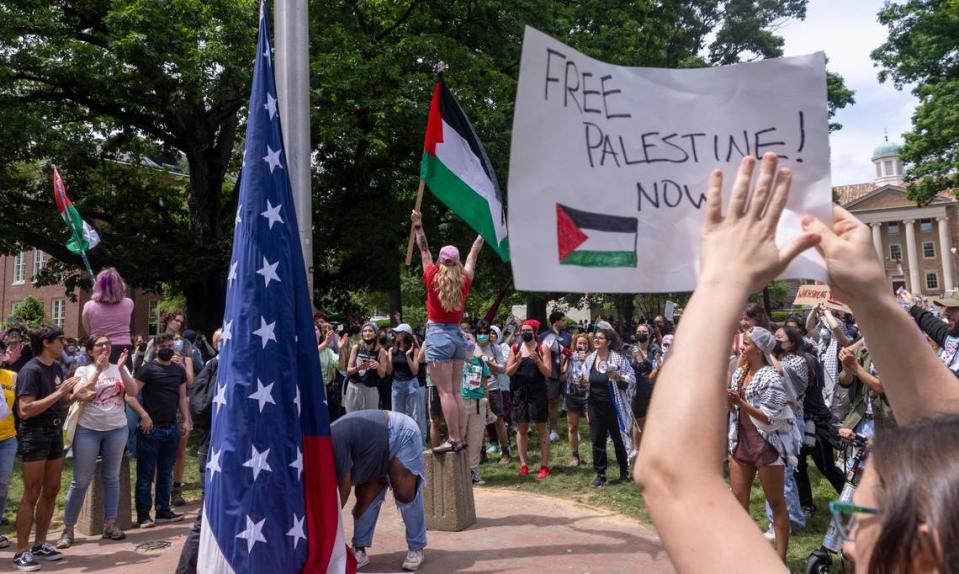 Pro-Palestinian demonstrators replace an American flag with a Palestinian flag Tuesday, April 30, 2024 at UNC-Chapel Hill. Police removed a “Gaza solidarity encampment” earlier Tuesday morning.