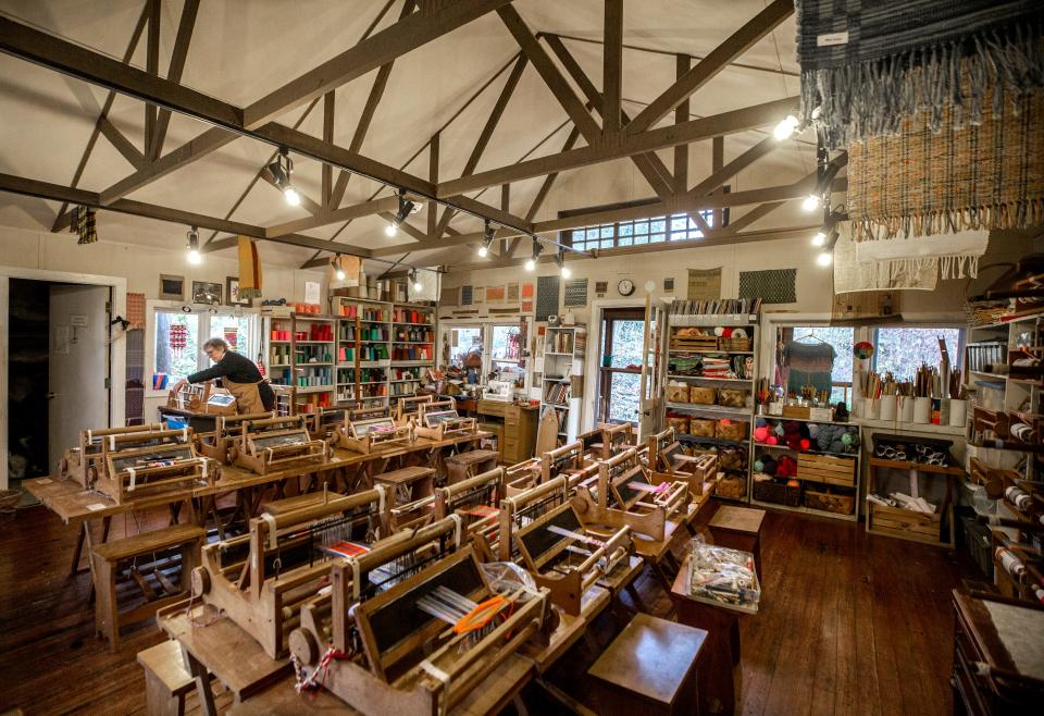 Sally Moss works on a loom at the Top House studio, part of the Little Loomhouse, on Kenwood Hill, in south Louisville. Dec. 9, 2021