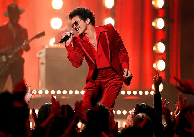 <p>John Esparza/Getty</p> Bruno Mars onstage for the 2021 American Music Awards on November 21, 2021 in Los Angeles, California.