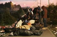 Migrants who slept outside on the street near the "Jungle" migrant camp in Calais, northern France