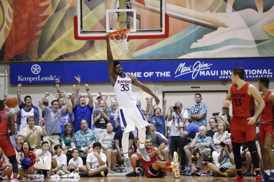 Kansas center Udoka Azubuike (35) hangs off the rim after making a slam dunk over Dayton in overtime of an NCAA college basketball game Wednesday, Nov. 27, 2019, in Lahaina, Hawaii. Kansas defeated Dayton in 90-84 in overtime. (AP Photo/Marco Garcia)