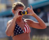 Kimberly Pavek takes a picture of a sand sculpture replica of the White House created by Meredith Corson is seen on the beach behind the Bilmar Beach Resort on August 23, 2012 in Treasure Island, Florida. The area waits for Tropical Storm Isaac as they prepare for the Repulican National Convention which will be held in Tampa during the week of August 27th. (Photo by Joe Raedle/Getty Images)