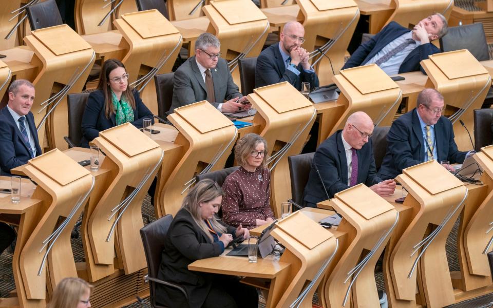 Kate Forbes (top, second left) and John Swinney (bottom, second right) at the Scottish Parliament