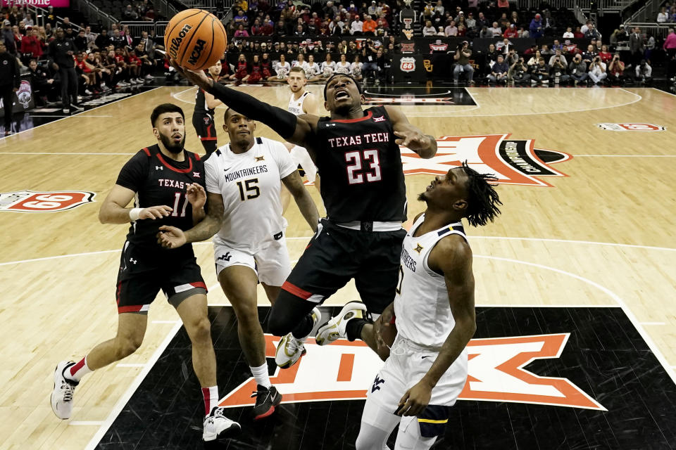 Texas Tech guard De'Vion Harmon (23) shoots over guard Kedrian Johnson (0) during the first half of an NCAA college basketball game in the first round of the Big 12 Conference tournament Wednesday, March 8, 2023, in Kansas City, Mo. (AP Photo/Charlie Riedel)