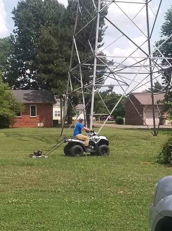 man pulling a push power with a four wheeler