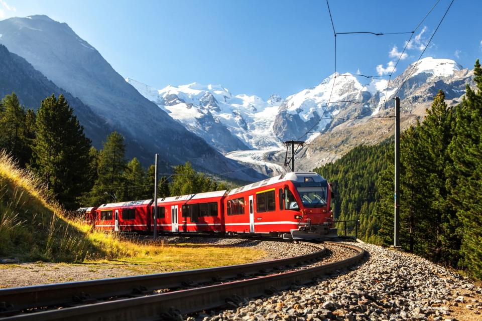 Swiss train in the alps mountains in switzerland around ospizio bernina