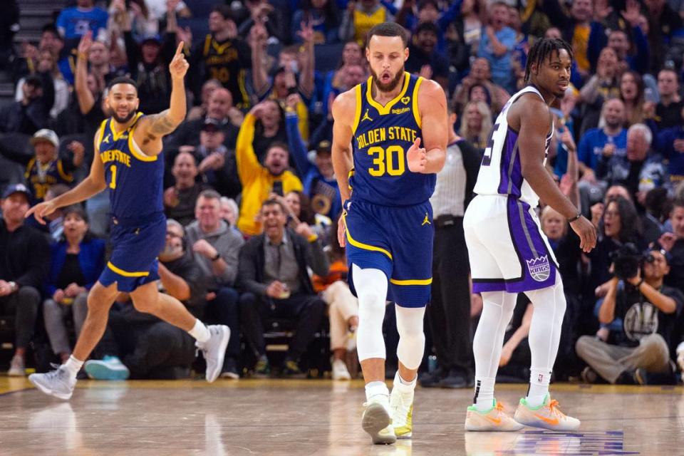 Golden State Warriors guard Stephen Curry (30) celebrates a 3-point basket in front of Sacramento Kings guard Davion Mitchell (15) during the first quarter Thursday, Jan. 25, 2024, at Chase Center in San Francisco.