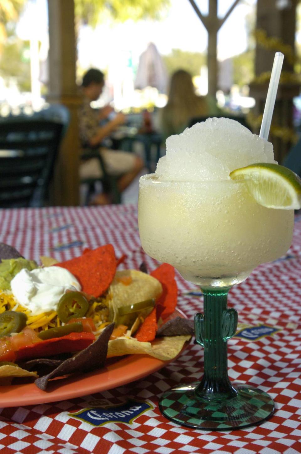 12/30/2004 -- A frozen margarita in a salted glass with the Nachos Grande appetizer on the patio at the Alvarez Mexican Restaurant in Palmetto.