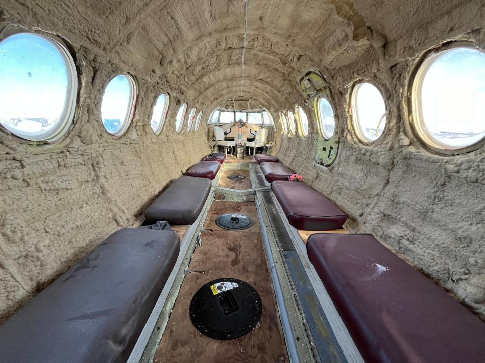 Benches line the sides of the decommissioned aircraft, which has four ice fishing holes and can hold up to 18 people.