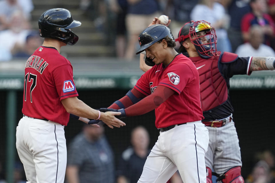 Cleveland Guardians' Bo Naylor, center, is congratulated on his home run by Will Brennan (17) in front of Minnesota Twins catcher Christian Vázquez in the third inning of a baseball game Tuesday, Sept. 5, 2023, in Cleveland. (AP Photo/Sue Ogrocki)