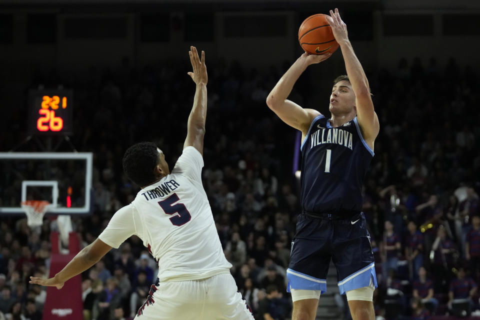 Villanova's Brendan Hausen, right, goes up for a shot against Pennsylvania's Cam Thrower during the first half of an NCAA college basketball game, Monday, Nov. 13, 2023, in Philadelphia. (AP Photo/Matt Slocum)