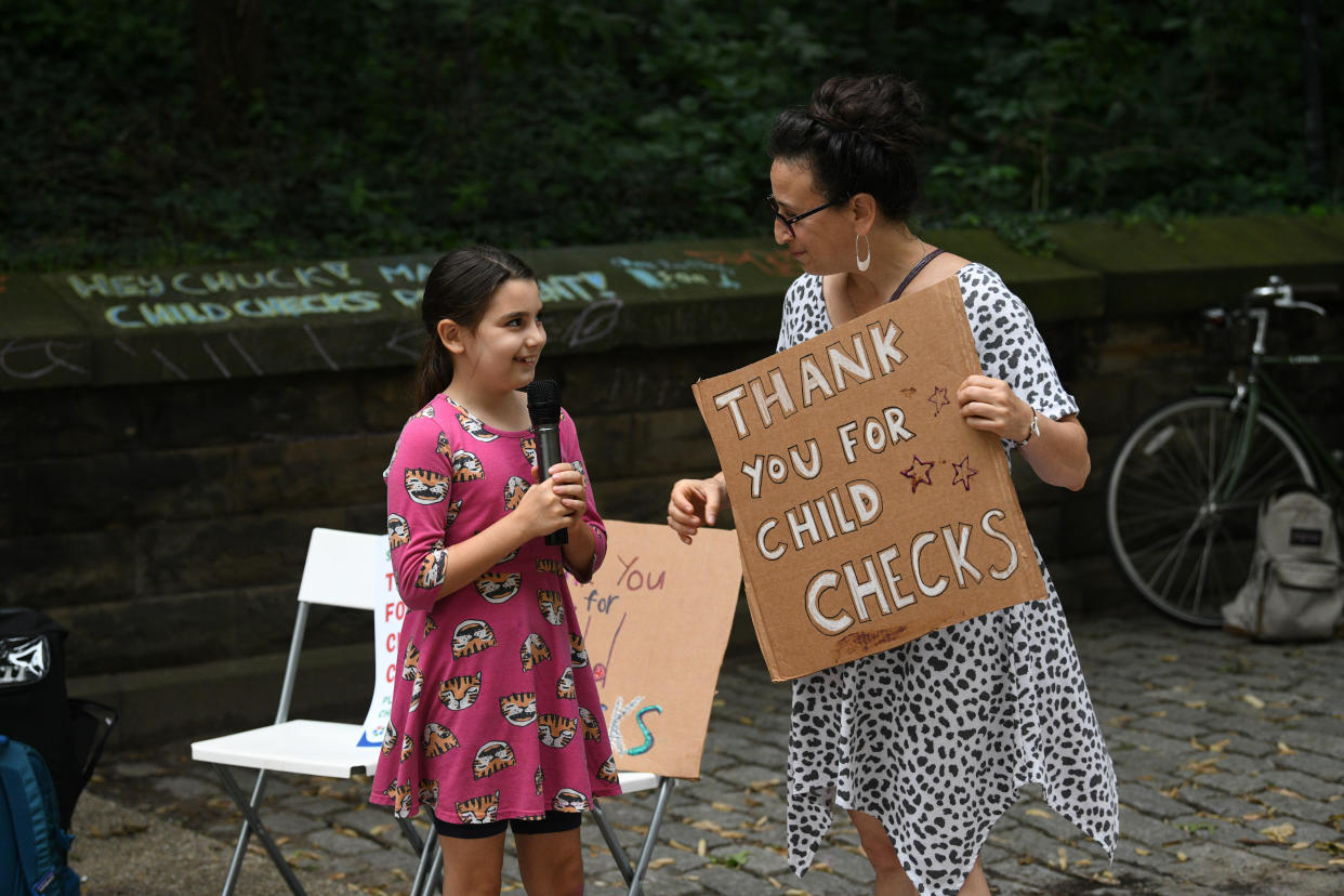 Edie Abrams-Pradt and Jen Abrams celebrate new monthly Child Tax Credit payments and urge Congress to make them permanent outside Senator Schumer's home on July 12, 2021, in Brooklyn, New York. (Photo by Bryan Bedder/Getty Images for ParentsTogether)