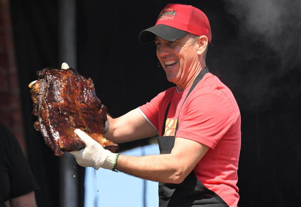 Adam White, general manager of Arthur Bryant’s Barbeque, pulled a brisket from the smoker at the KC Smoke Show at the NFL Draft on Saturday, April 29, 2023, in Kansas City.
