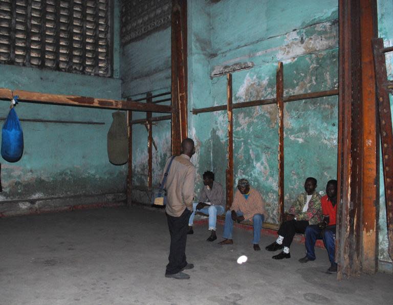 Athletes stand inside the rundown room that once served as the dressing room for Mohamed Ali in his famous 1974 fight against George Foreman at the Tata Raphaël stadium in Kinshasa on October 29, 2009