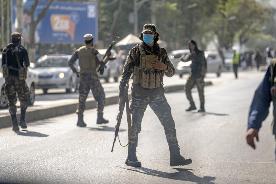 Taliban fighters stand guard at the explosion site, near a mosque, in Kabul, Afghanistan, Friday, Sept. 23, 2022. An explosion went off near a mosque in Afghanistan's capital of Kabul on Friday, with police confirming casualties. A column of black smoke rose into the sky and shots rang out several minutes after the blast in the city's diplomatic quarter. (AP Photo/Ebrahim Noroozi)