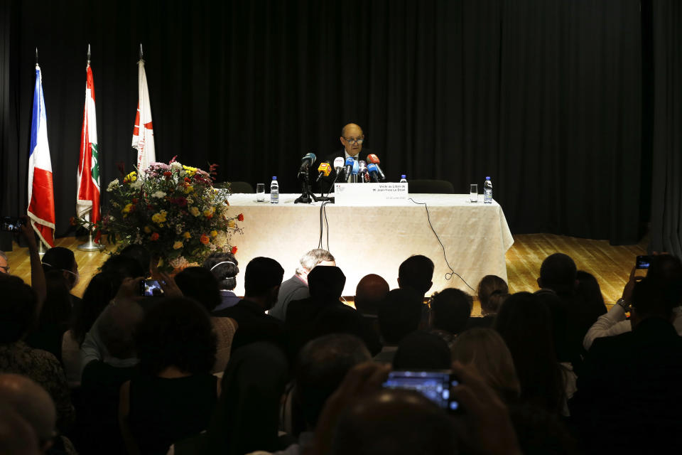 French Foreign Minister Jean-Yves Le Drian, center, speaks during his visit to the Carmel Saint Joseph school in Mechref district, south of the capital Beirut, Lebanon, Friday, July 24, 2020. Le Drian pledged on Friday €15 million ($17 million) in aid to Lebanon's schools, struggling under the weight of the country's major economic crisis. (AP Photo/Bilal Hussein)