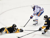 Pittsburgh Penguins defenseman Chad Ruhwedel (2) stops the puck on a shot by Edmonton Oilers left wing Warren Foegele (37) during the first period of an NHL hockey game, Thursday, Feb. 23, 2023, in Pittsburgh. (AP Photo/Philip G. Pavely)