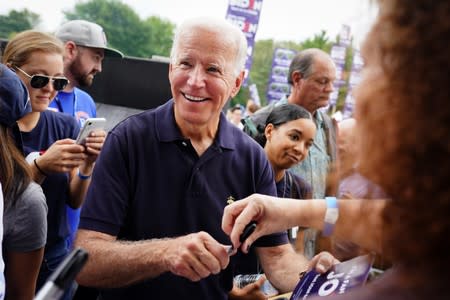 Biden smiles while signing autographs at the Polk County Democrats' Steak Fry in Des Moines, Iowa