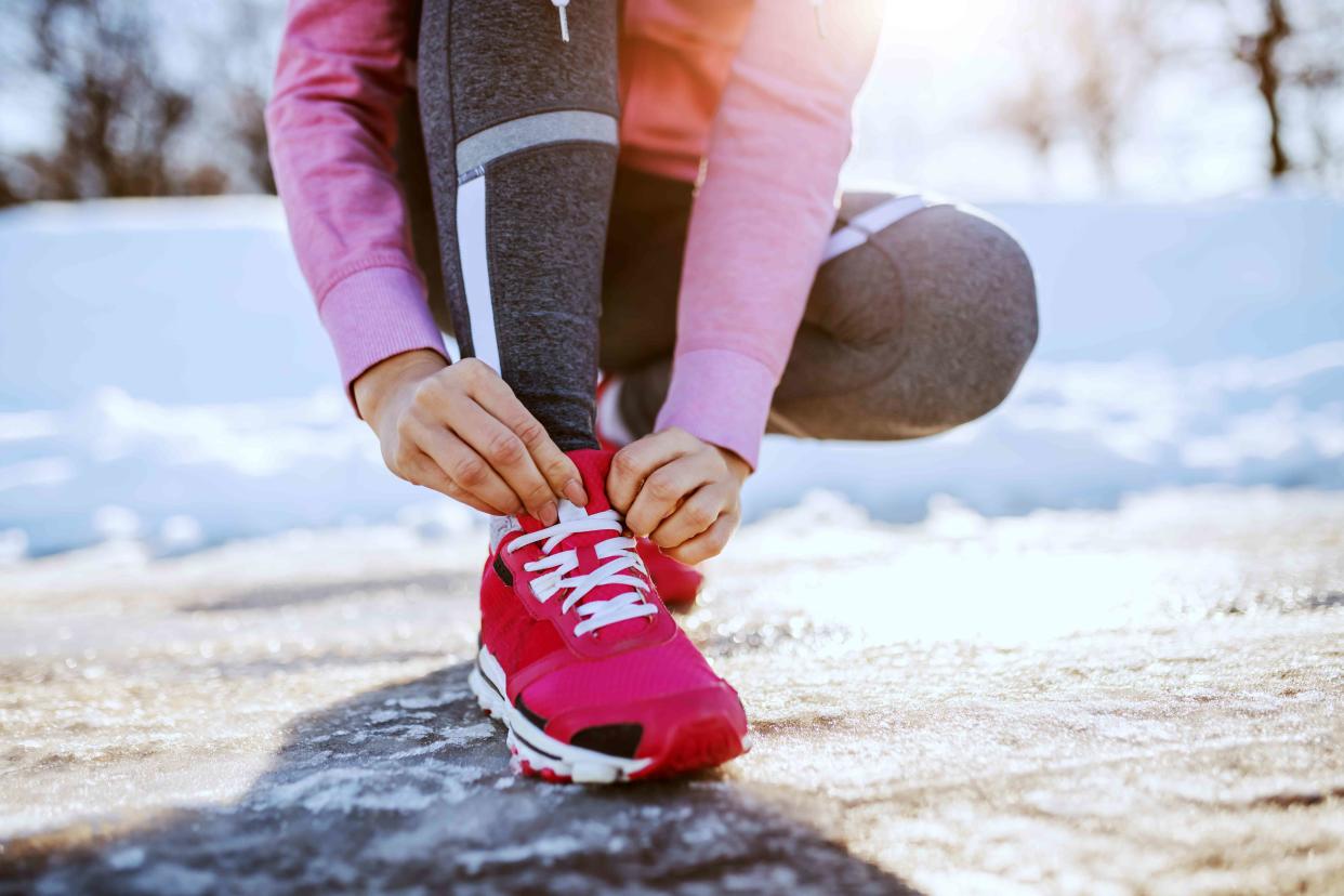 <p>Getty Images / <a href="https://www.gettyimages.com/search/photographer?photographer=dusanpetkovic">dusanpetkovic</a></p> Woman lacing up her sneakers