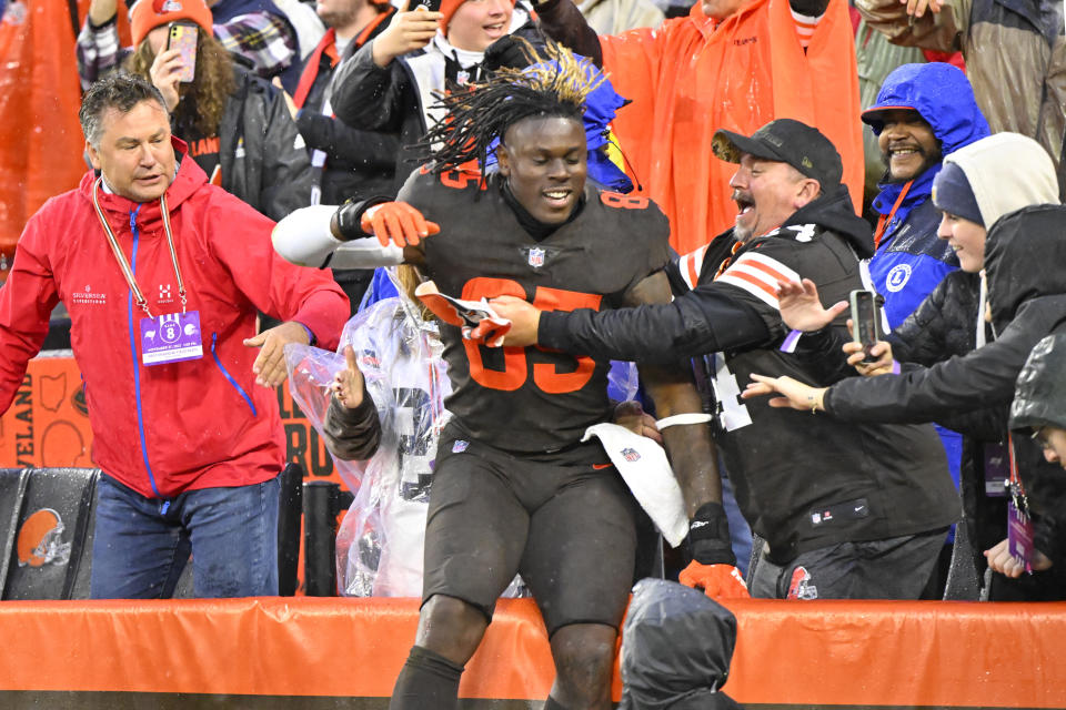 Cleveland Browns tight end David Njoku jumps into the stands following the team's 23-17 overtime win over the Tampa Bay Buccaneers in an NFL football game in Cleveland, Sunday, Nov. 27, 2022. (AP Photo/David Richard)