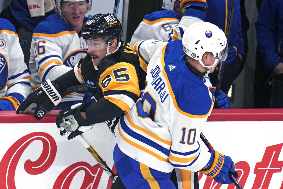 Buffalo Sabres' Henri Jokiharju (10) checks Pittsburgh Penguins' Erik Karlsson during the first period of an NHL hockey game in Pittsburgh, Saturday, Nov. 11, 2023. (AP Photo/Gene J. Puskar)