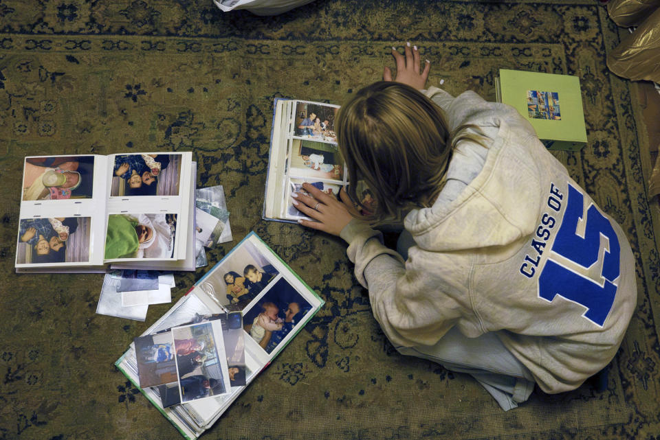 15-year-old Ksiusha Mukhovata shows pictures of her family in the village of Hroza near Kharkiv, Ukraine, Friday, Oct. 6, 2023. Her parents were killed as the Russian rocket hit a village store and cafe in one of the deadliest attacks in recent months, killing at least 51 civilians. (AP Photo/Alex Babenko)