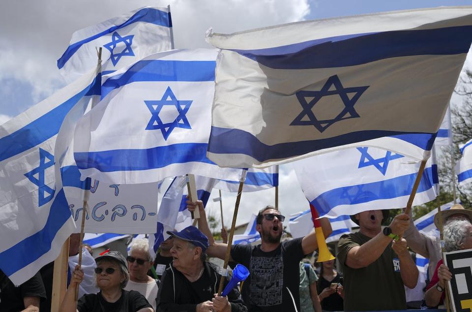 The Israeli flag has become a contested symbol recently as both anti-government and far-right demonstrators use it to bolster their message. (AP Photo/Tsafrir Abayov)
