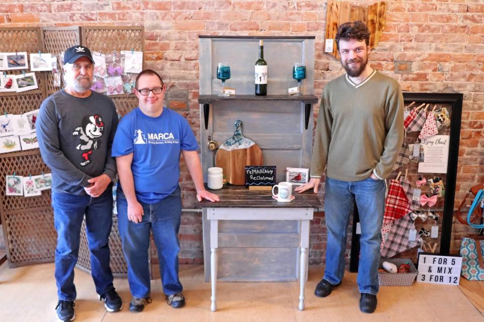 Randy Boldman, Bobby Wanamaker and Nick Freshwater pose in front of a shelf they made. reMARCAbly Reclaimed has been making furniture for five months. They take donations of solid wood pieces and turn them into end tables, wine racks, and other furniture that is sold at the reMARCAble store.