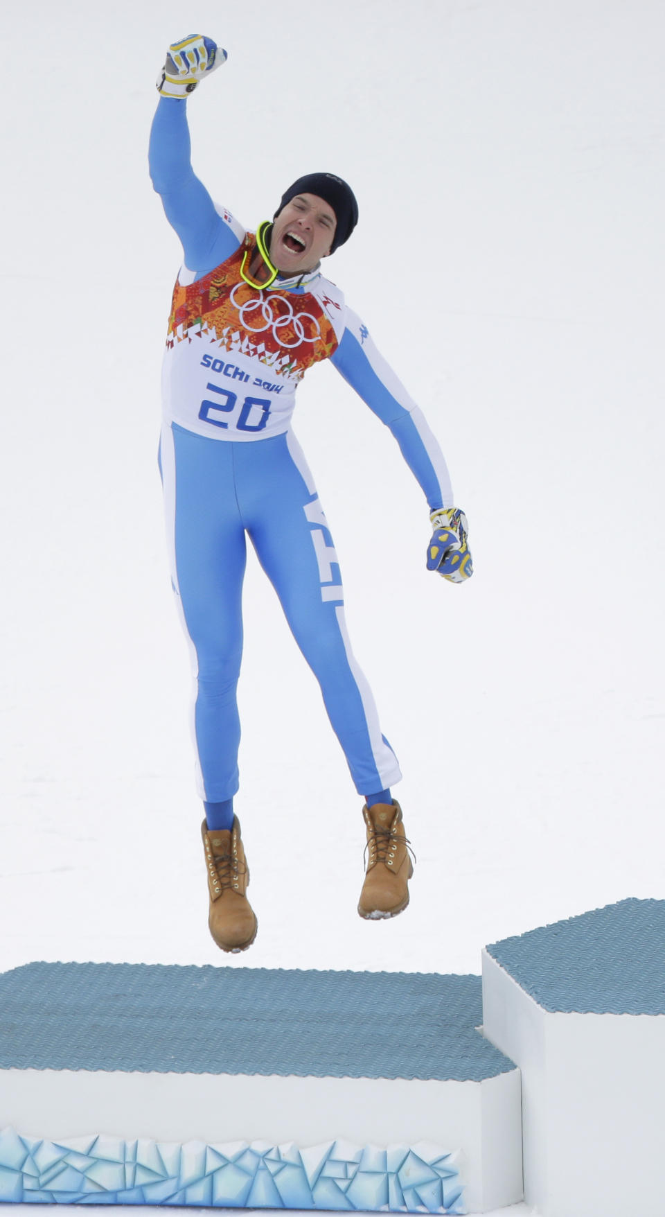 Italy's Christof Innerhofer celebrates during the flower ceremony after finishing the mens's downhill event at the 2014 Winter Olympics, Sunday, Feb. 9, 2014, in Krasnaya Polyana, Russia. Innerhofer finished second in the event. (AP Photo/Charlie Riedel)