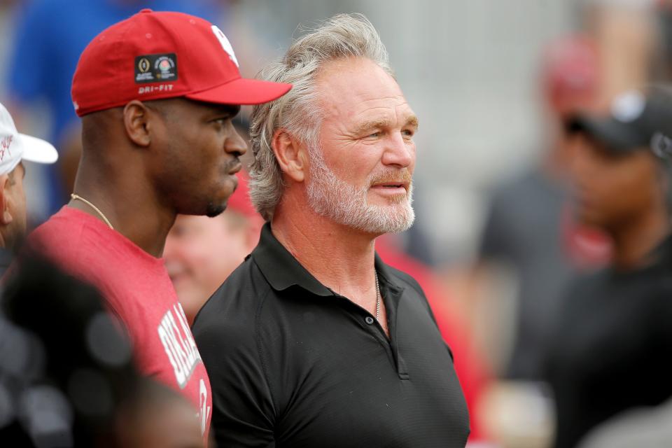 Former OU football players Brian Bosworth, right, and Adrian Peterson watch the Sooners' spring game Saturday at Gaylord Family-Oklahoma Memorial Stadium in Norman.