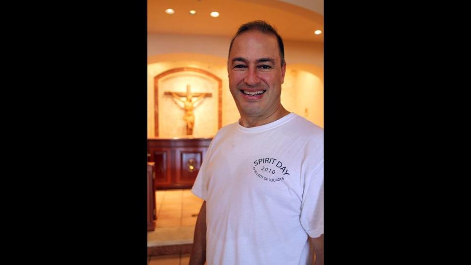 Elkin Sierra, age 46, poses inside St. Robert Bellarmine Church as he takes a break from helping to clean and restore it on Thursday, August 26, 2010. Sierra has been a firefighter for 21 years and had entered the seminary that month.