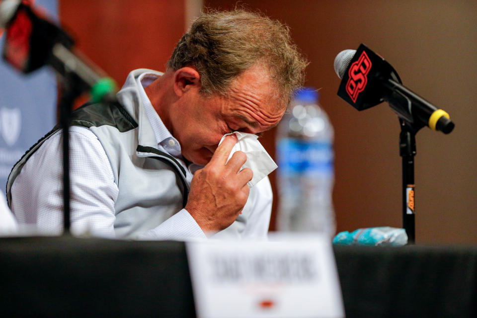 OSU wrestling coach John Smith wipes away tears Monday morning in Stillwater at a news conference for his retirement. Smith, a two-time Olympic gold medalist, led his alma mater to five NCAA championships in 33 years.