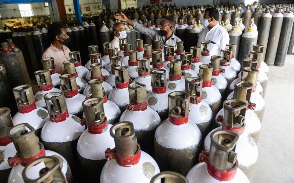 Workers prepare to transport much-needed medical oxygen cylinders to hospitals outside Hyderabad - Noah Seelam/AFP