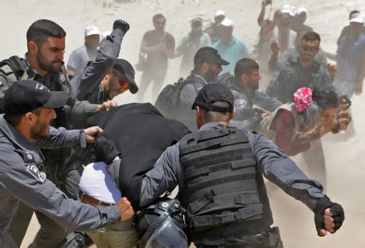 Israeli police scuffle with demonstrators in the Palestinian Bedouin village of Khan al-Ahmar in the occupied West Bank on July 4, 2018