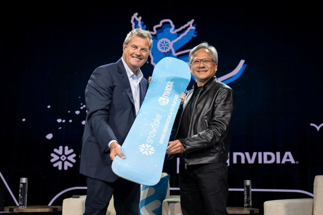 Snowflake Chairman and CEO Frank Slootman presents a snowboard as a gift to NVIDIA CEO Jensen Huang at Snowflake Summit 2023, in Las Vegas, Nevada, U.S. June 26, 2023.    Courtesy of Snowflake/Handout via REUTERS    THIS IMAGE HAS BEEN SUPPLIED BY A THIRD PARTY