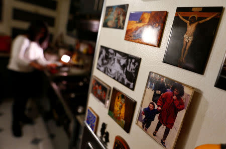 Maha Ragaay is seen near a photo of Jesus as she prepares a meal for breaking fast at her home in the Cairo suburb of Maadi, Egypt, April 14, 2017. REUTERS/Amr Abdallah Dalsh