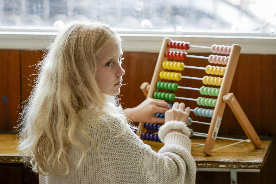 Student Regan White, 10, uses a colorful abacus at Springfield Preparatory School in Springfield, La., Thursday, July 27, 2023. Nearly 9,000 private schools in Louisiana don’t need state approval to grant degrees. Non-approved schools make up a small percentage of the state total. But the students in Louisiana’s off-the-grid school system are a rapidly growing example of the national fallout from COVID-19 — families disengaging from traditional education. (AP Photo/Scott Threlkeld)
