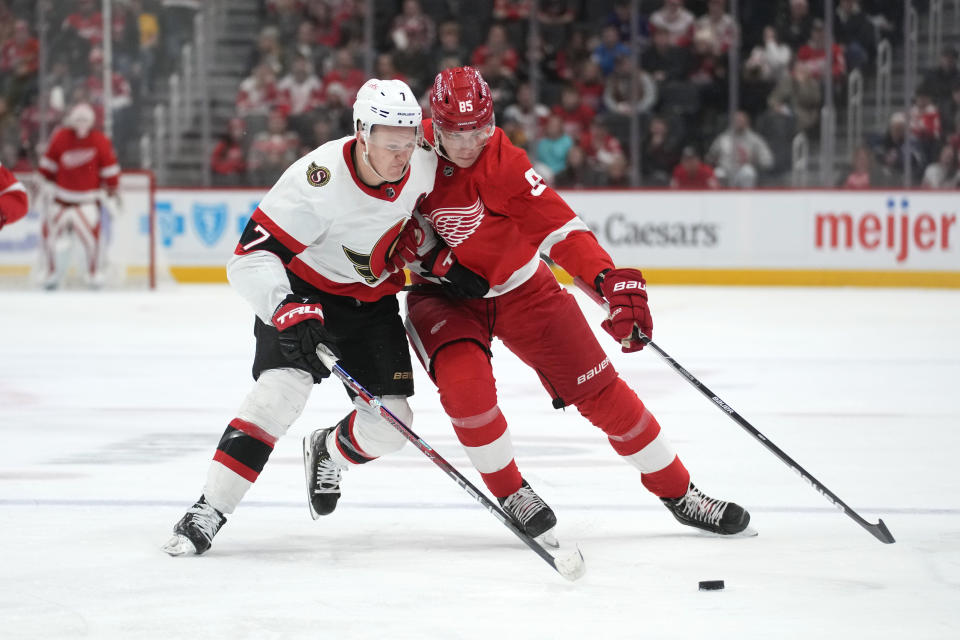 Ottawa Senators left wing Brady Tkachuk (7) and Detroit Red Wings left wing Elmer Soderblom (85) battle for the puck in the second period of an NHL hockey game Saturday, Dec. 17, 2022, in Detroit. (AP Photo/Paul Sancya)