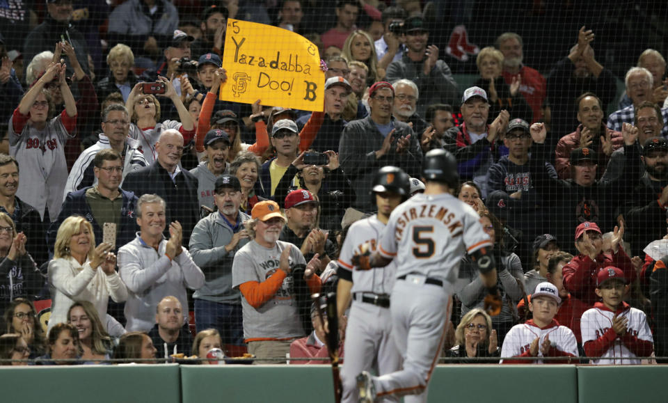 Fans cheer after a solo home run by San Francisco Giants' Mike Yastrzemski (5) in the fourth inning of a baseball game against the Boston Red Sox at Fenway Park in Boston, Tuesday, Sept. 17, 2019. Yastrzemski is the grandson of Red Sox great and Hall of Famer Carl Yastrzemski. (AP Photo/Charles Krupa)