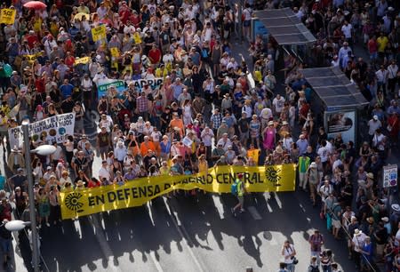 Demonstrators take part in a protest against Madrid's new conservative People's Party (PP) municipal government plans to suspend some anti-car emissions policies in Madrid's city center