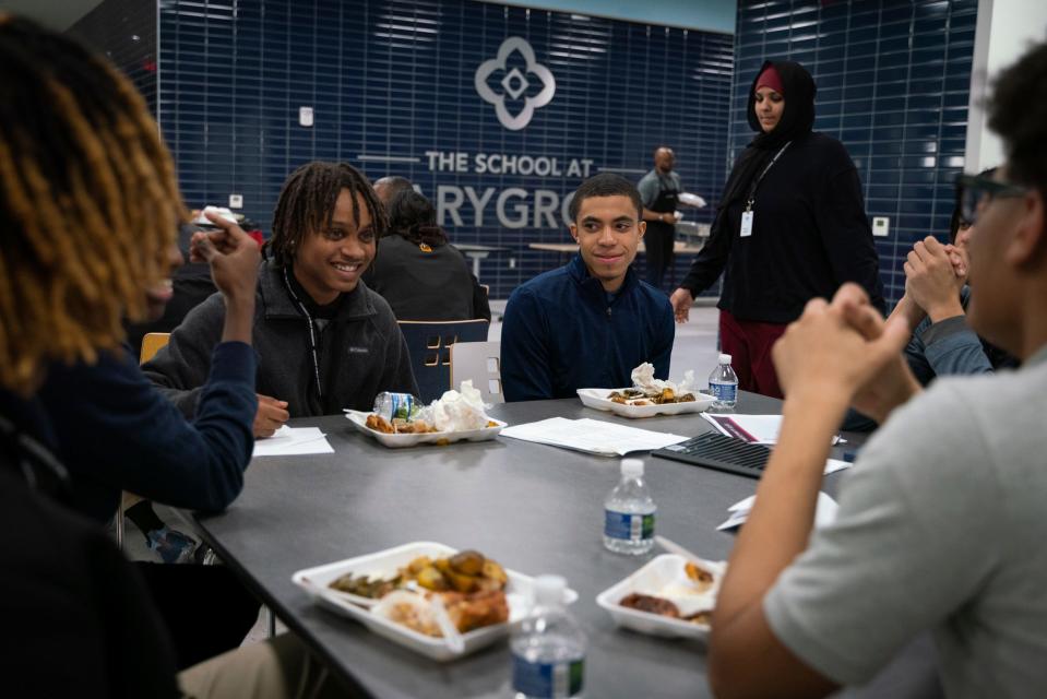 Jaiden Reed, 17, of Southfield, left, and Justin Dubois, 17, of Detroit, joke after eating dinner with friends during the Midnight Golf Program at Marygrove Conservancy in northwest Detroit, Tuesday, Feb. 7, 2023.