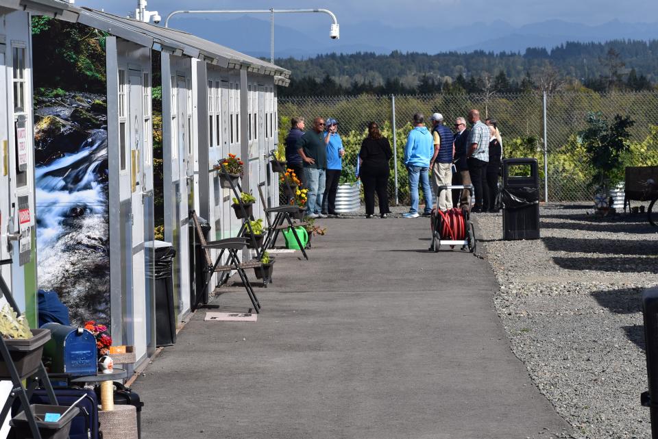 Bremerton leaders in addressing the city's homelessness crisis gather at the Everett Gospel Mission's Palisades Village, a "tiny-home" adjacent shelter for homeless folk on the way to permanent housing.