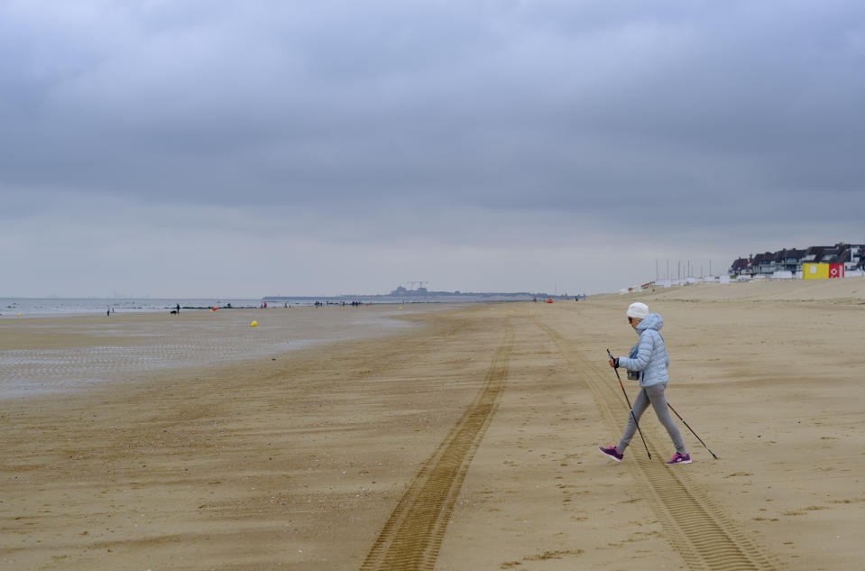 A woman practice nordic walk on the beach on June 25, 2021 in Knokke, Belgium.