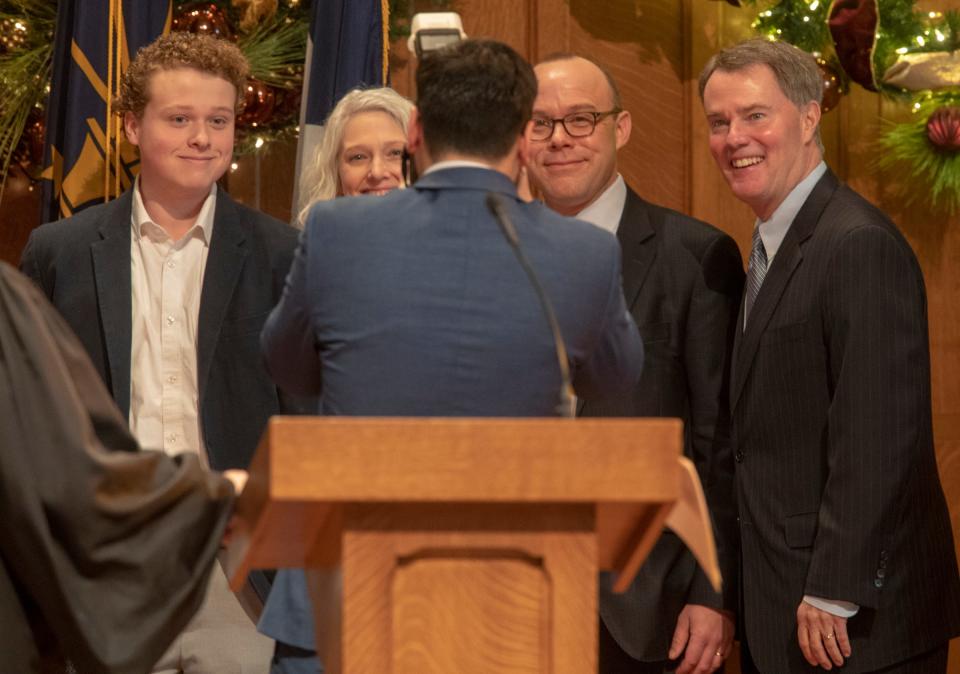 John Barth (second from right), smiles as he, family and Mayor Joe Hogsett (far right), have their photo made a swearing-in ceremony for Hogsett, and incoming City-County Council members, Indianapolis, Wednesday, Jan. 1, 2020.