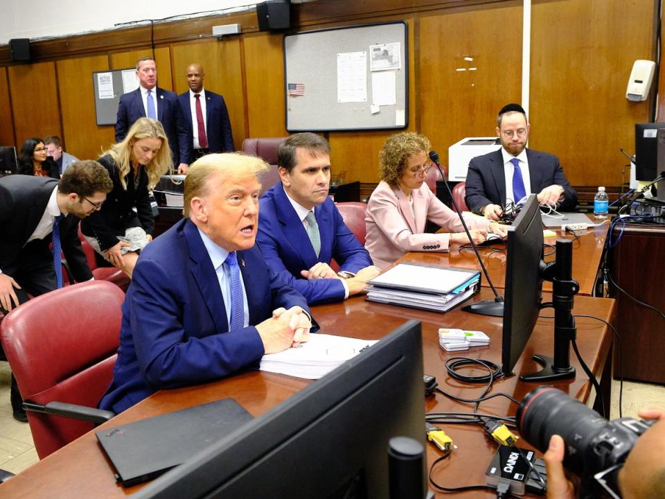 The former president sits with his attorneys in court in Manhattan (EPA)