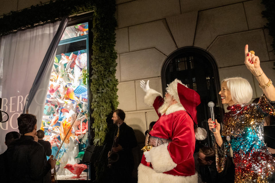 NEW YORK, NEW YORK - NOVEMBER 18: Bergdorf Goodman Fashion Director Linda Fargo (R), and Santa Claus cheer at the Bergdorf Goodman Holiday Windows unveiling on November 18, 2021 in New York City. This year’s theme is “The Present Moment,