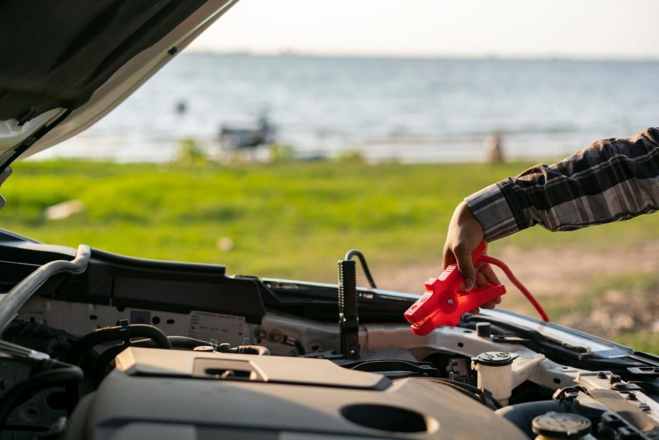 A person jumpstarts their car.